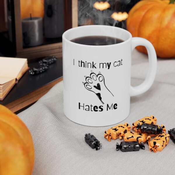 Embrace your feline friend's enigmatic charm with our "I think my cat hates me" 11 oz Coffee Mug! - Image 3