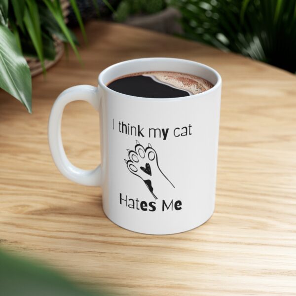 Embrace your feline friend's enigmatic charm with our "I think my cat hates me" 11 oz Coffee Mug! - Image 5